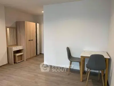 Modern minimalist interior with wooden flooring and sleek furniture in a cozy apartment.