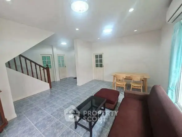 Spacious living room with modern furniture and natural light, perfect for family gatherings.
