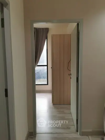 Cozy bedroom entrance with natural light and modern wooden flooring