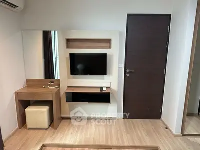 Modern living room with sleek TV setup and stylish wooden furniture