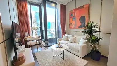 Modern living room with city view, stylish decor, and large windows in a high-rise apartment.