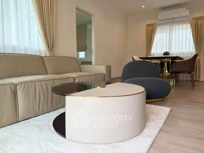 Modern living room with elegant furniture and natural light, perfect for relaxation and entertaining.