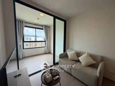 Modern living room with cozy sofa and large window offering city view