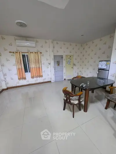 Spacious dining area with elegant wallpaper and modern furniture in a cozy home setting.