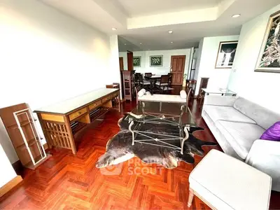 Spacious living room with elegant wooden flooring and stylish furniture