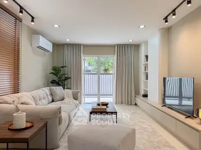 Spacious modern living room with cozy sofa and large window view