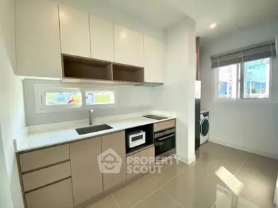Modern kitchen with sleek cabinetry and built-in appliances in a bright, airy space.