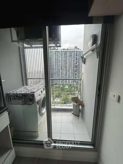 Modern apartment balcony with washing machine and city view, perfect for urban living.