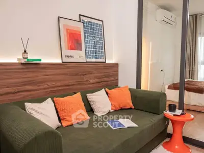 Modern living room with stylish decor and cozy green sofa in a contemporary apartment.