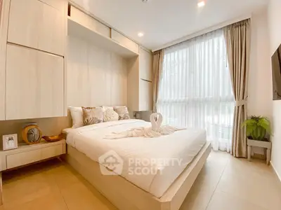 Elegant bedroom with natural light, modern furnishings, and cozy ambiance, perfect for relaxation and comfort.