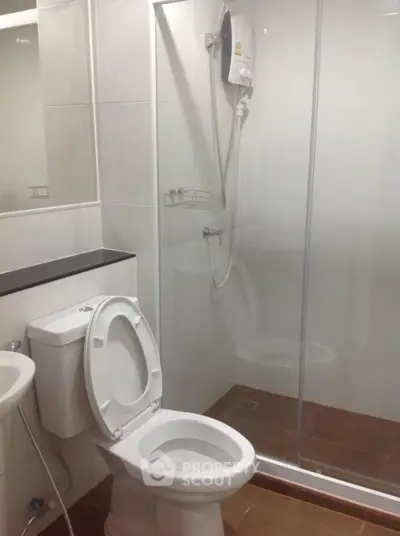 Modern bathroom with glass shower and sleek white fixtures