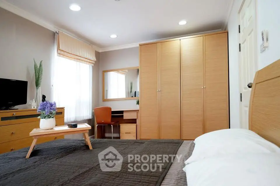 Spacious bedroom with modern furniture and natural light