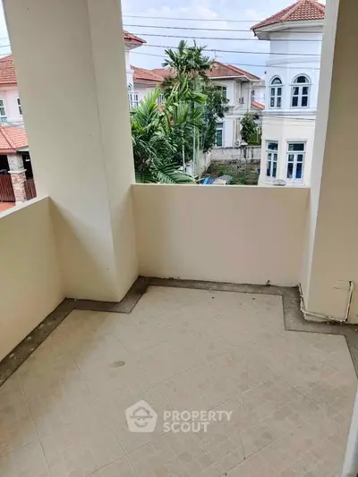 Spacious balcony with scenic view of elegant residential neighborhood.