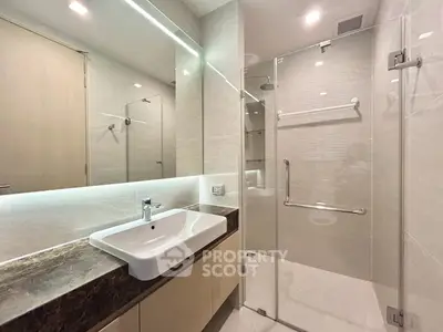 Modern bathroom with glass shower and sleek sink design