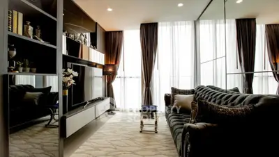 Luxurious living room with elegant decor, plush sofa, and floor-to-ceiling windows for natural light.