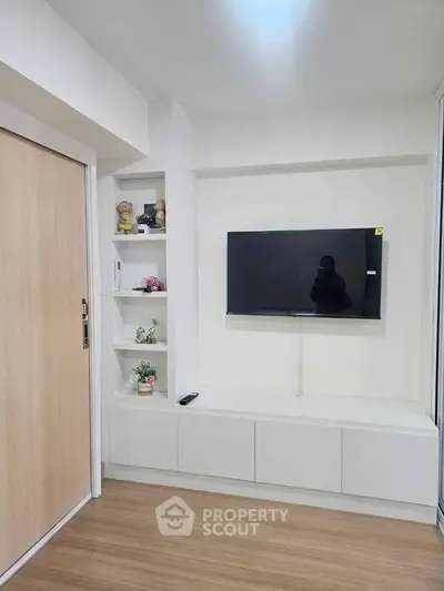 Modern living room with wall-mounted TV and built-in shelving