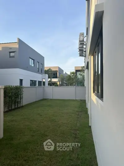 Modern townhouse exterior with private garden and contemporary design.