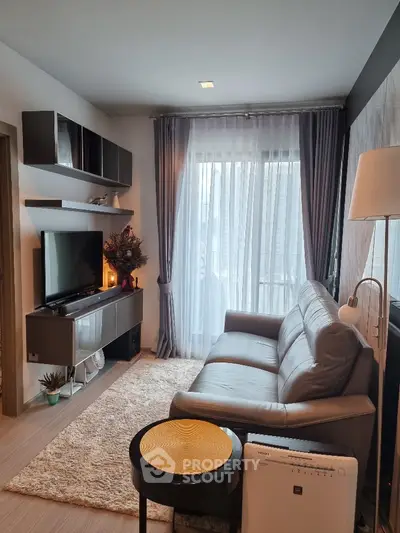 Modern living room with sleek furniture and large window for natural light