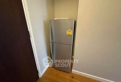Compact kitchen corner with modern fridge in cozy apartment