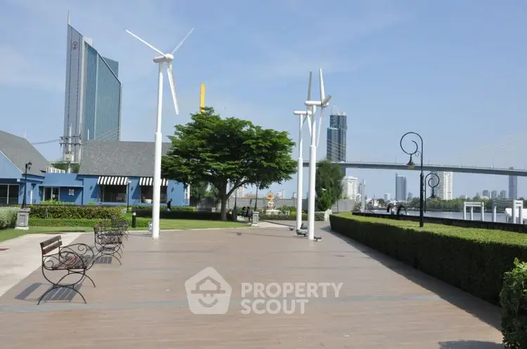 Modern urban park with wind turbines and city skyline view