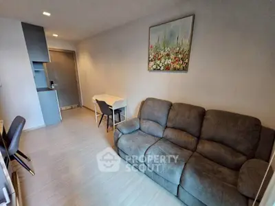 Modern living room with cozy sofa and stylish decor in a contemporary apartment.