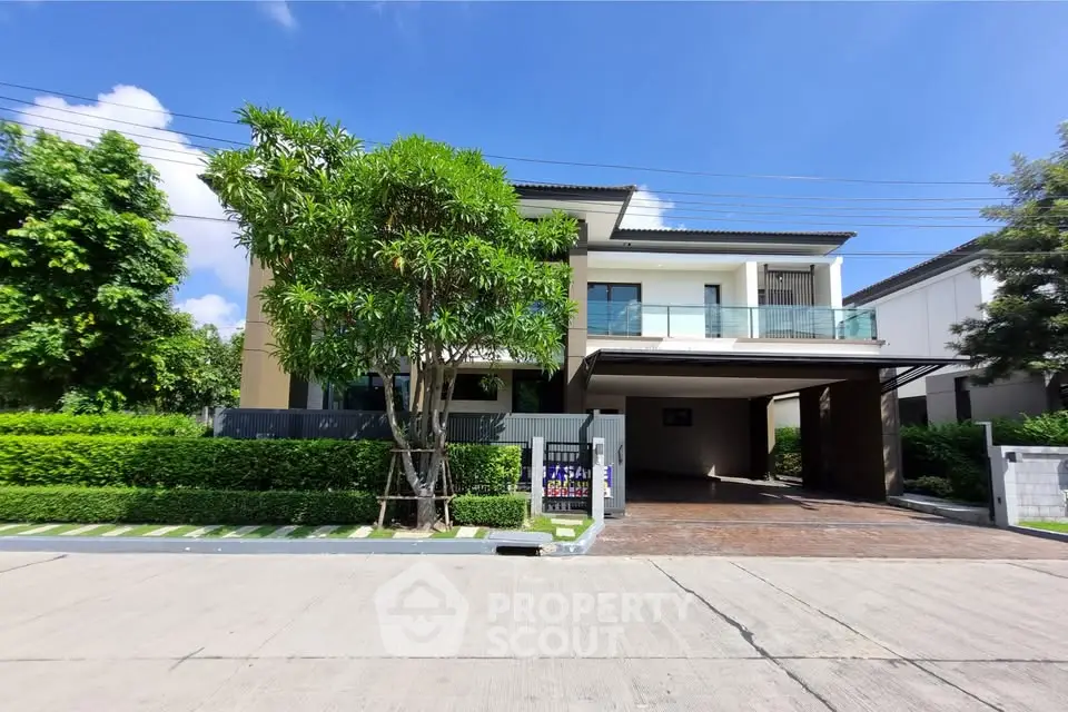 Modern two-story house with lush greenery and spacious driveway in a serene neighborhood.