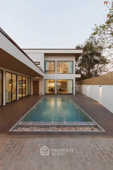 Luxurious modern home with stunning pool and elegant architecture.