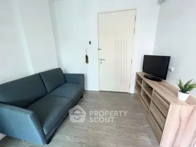 Cozy living room with modern sofa and TV unit, perfect for relaxation.