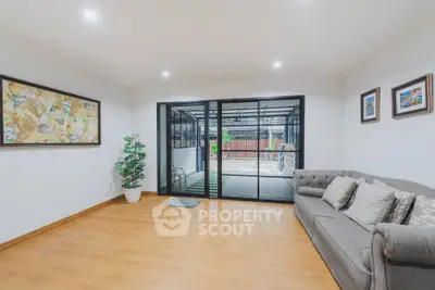 Spacious living room with modern decor and sliding glass doors leading to patio