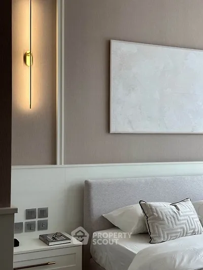 Elegant bedroom with modern lighting and neutral decor