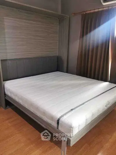 Modern bedroom with stylish bed and wooden flooring, perfect for a cozy living space.