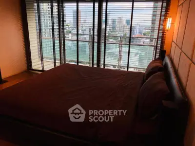 Spacious bedroom with city view and large windows in modern apartment