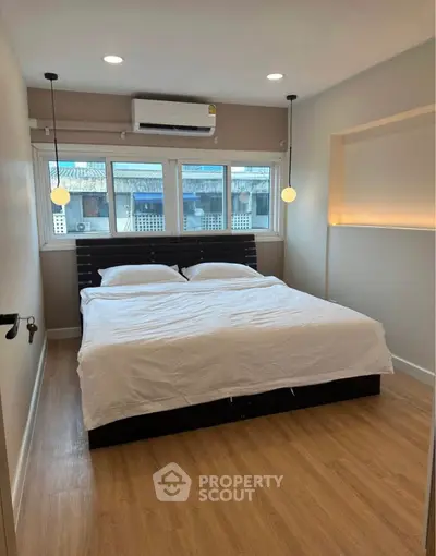 Cozy bedroom with modern design and ample natural light