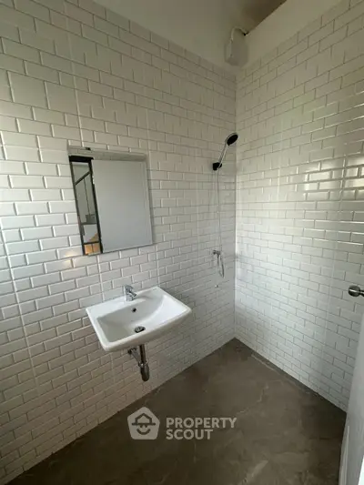 Modern minimalist bathroom with white subway tiles and sleek fixtures