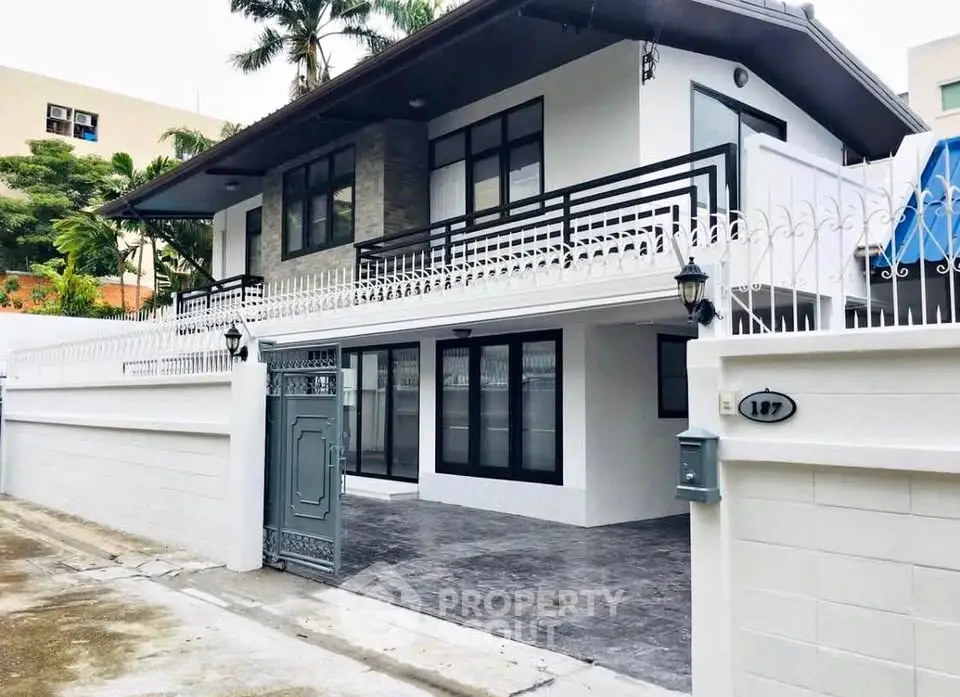 Stunning modern two-story house with sleek design and spacious driveway, perfect for family living.