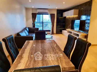Spacious modern living room with elegant dining area and city view balcony.