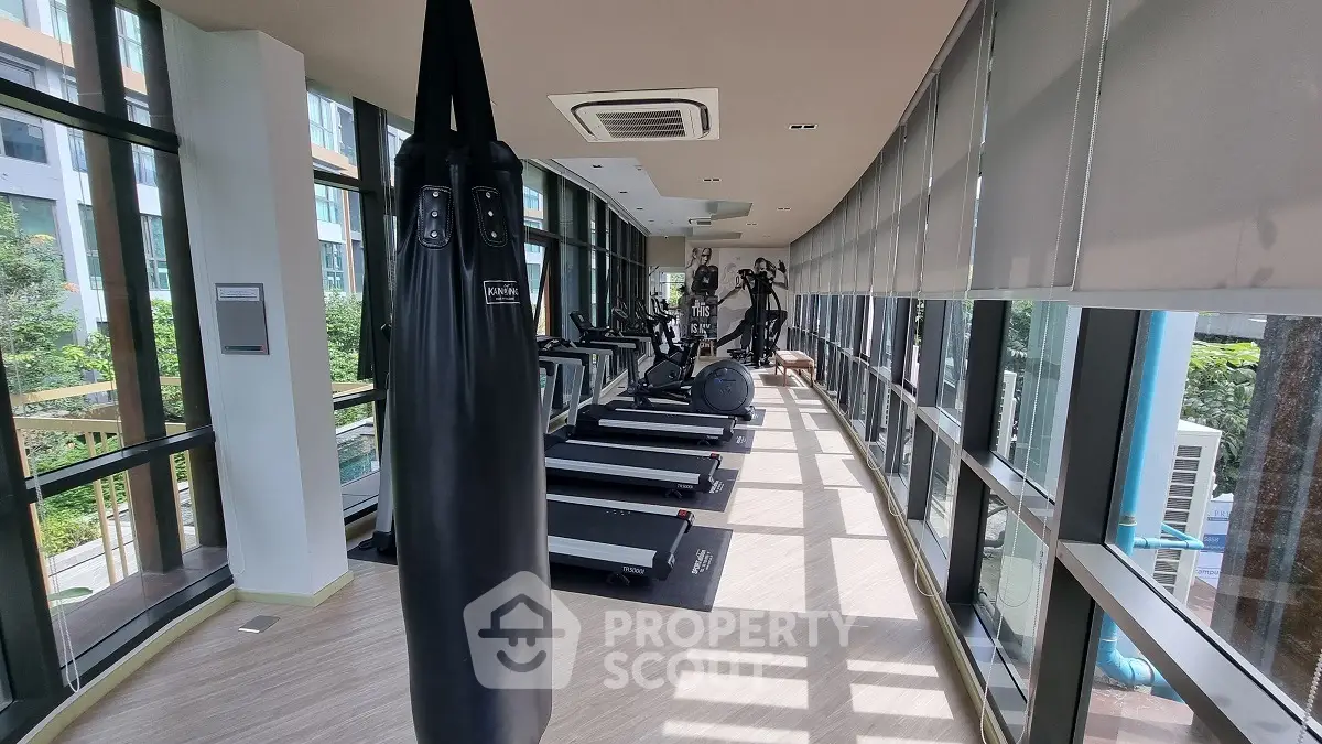 Modern gym with large windows and fitness equipment in a high-rise building