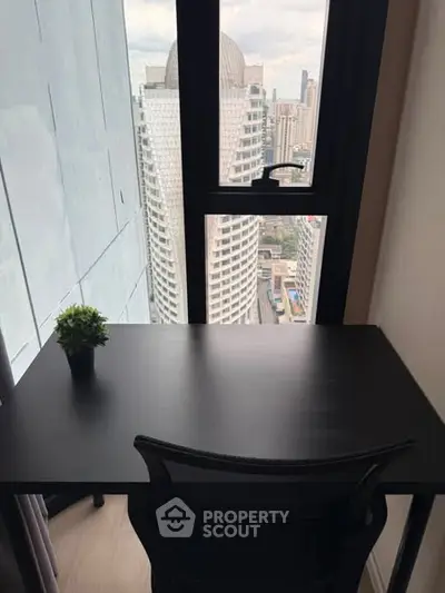 Modern study area with city view from high-rise apartment window.