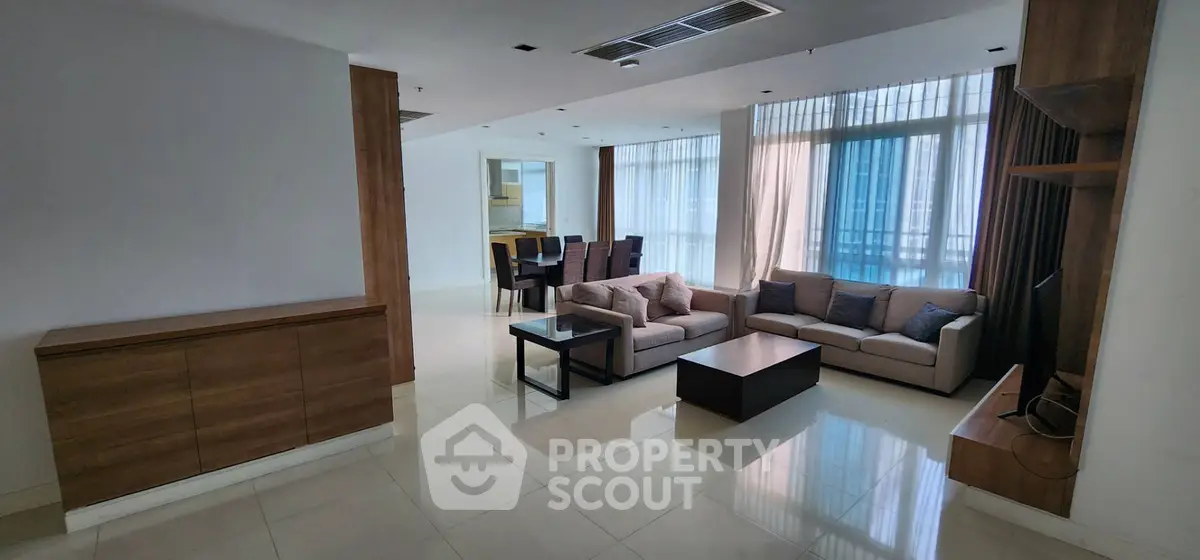 Spacious modern living room with elegant dining area and large windows