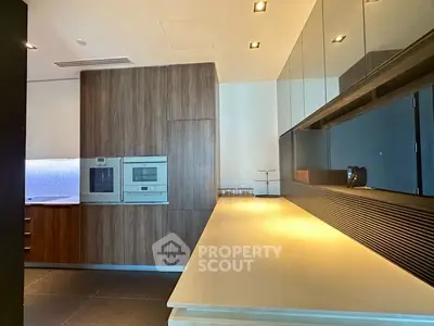 Modern kitchen with sleek cabinetry and built-in appliances