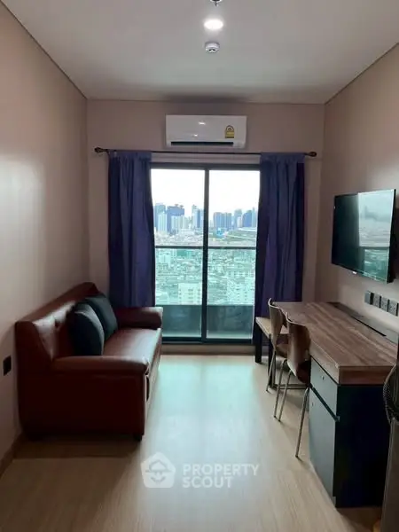 Modern living room with city view, featuring a leather sofa and wall-mounted TV.