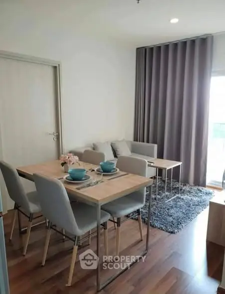Modern living room with dining area, stylish furniture, and elegant decor