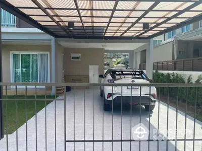 Modern home with covered carport and sleek white car in driveway