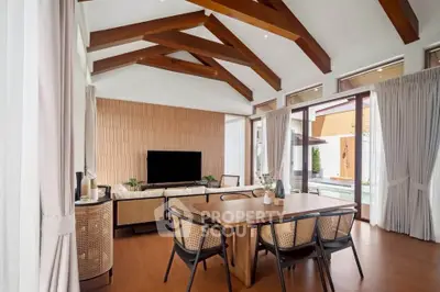 Stunning modern living room with wooden beams and pool view