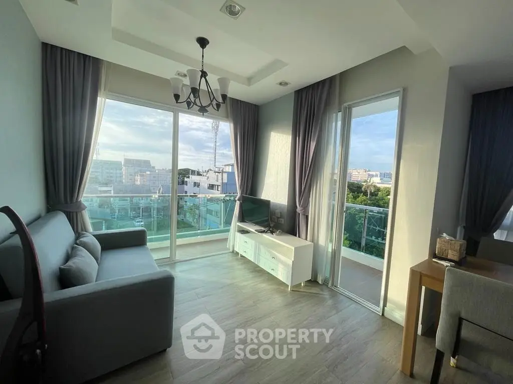 Modern living room with large windows and balcony view in a stylish apartment
