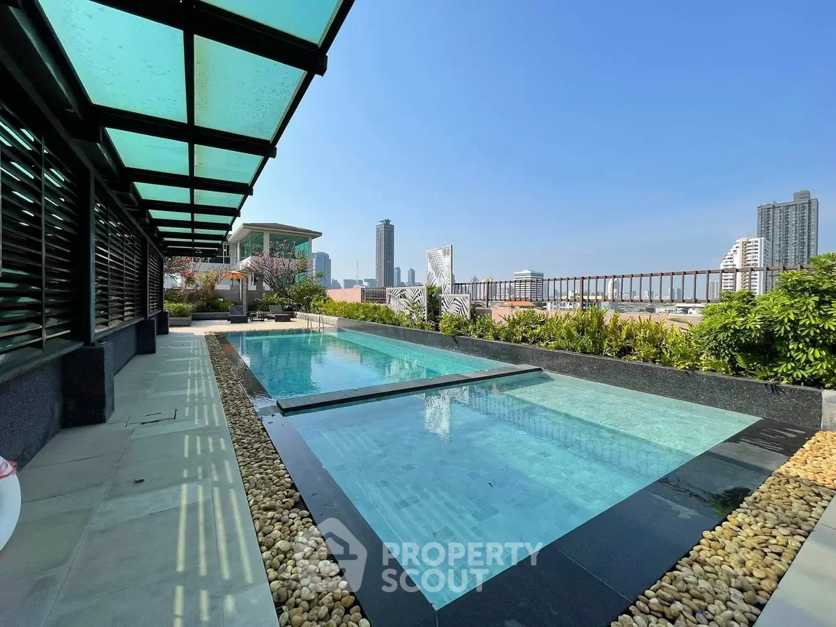 Luxurious rooftop pool with stunning city skyline views, perfect for relaxation and entertainment.