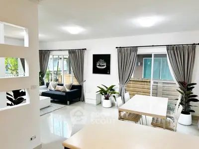 Spacious modern living room with elegant dining area and large windows