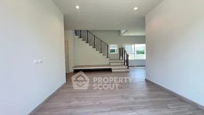 Spacious modern interior with elegant staircase and natural light