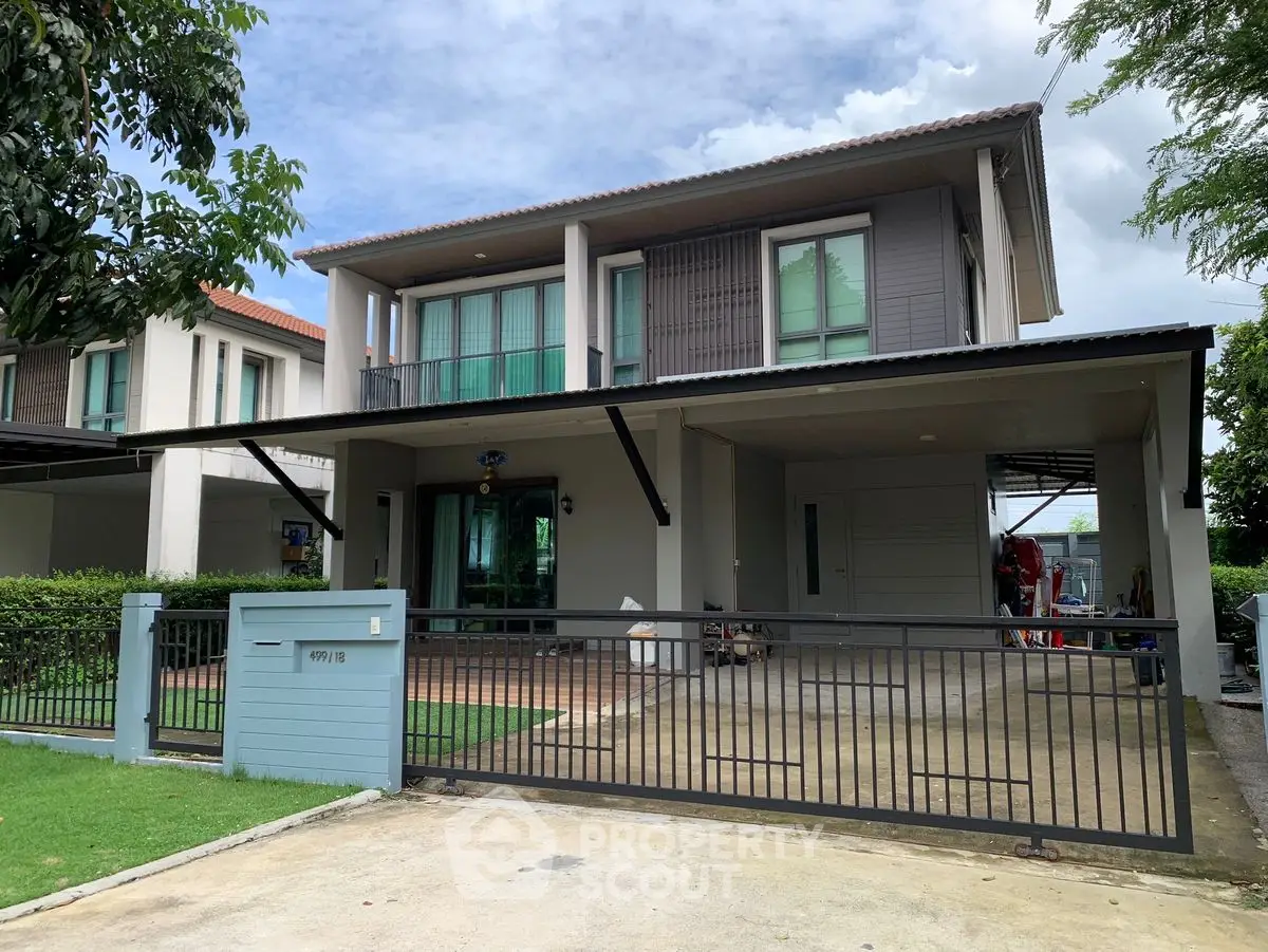 Modern two-story house with spacious driveway and lush greenery, perfect for family living.