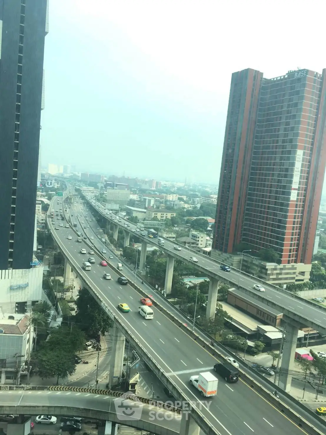 Stunning cityscape view with modern high-rise buildings and elevated highways, perfect for urban living.